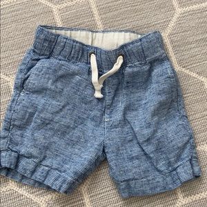 Boys pull on shorts.